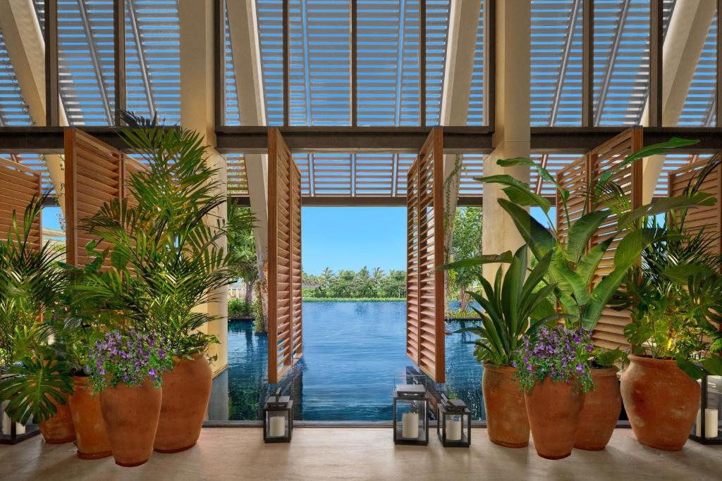 Luxury lobby entrance at The Riviera Maya EDITION at Kanai surrounded by tropical design and modern architecture