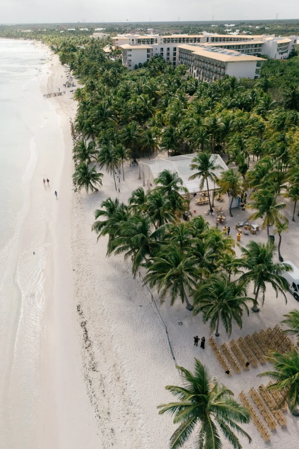 Aerial view of Saasil Kantenah beachfront wedding venue surrounded by palm trees in the Riviera Maya